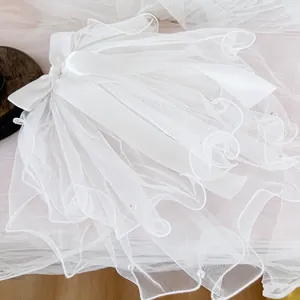 Elegant white pet wedding veil with layered mesh, pearl beads and a large satin bow detail