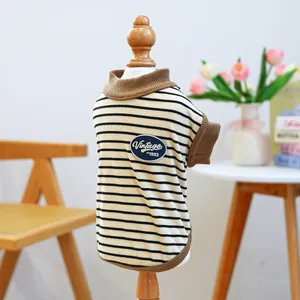 Detail of striped pet sweater with vintage patch on a wooden mannequin display