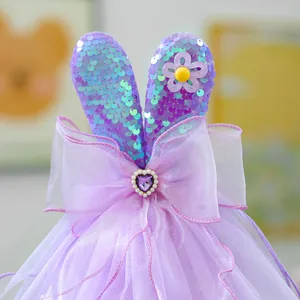 Close-up of Easter pet dress detail with sequin bunny ears and organza bow decoration