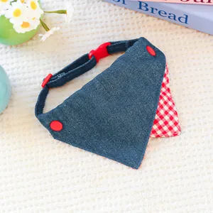 Detail of blue denim pet bandana with red checkered lining and safety buckle