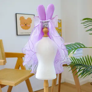Close-up of purple rabbit ear mesh veil with bow and metal clip for small dogs