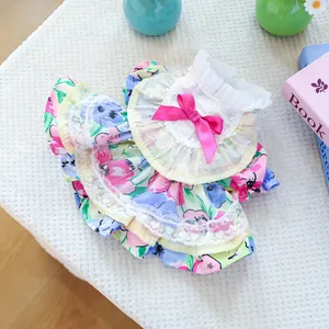Detailed view of floral pet dress with ruffled collar, pink bow, and white lace trim
