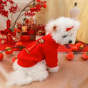 Close-up of red festive dog hoodie with bear embroidery and Chinese New Year scroll
