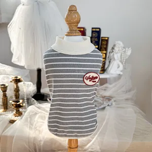 Vintage style striped dog vest with 1993 patch on a wooden mannequin in retro setting