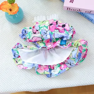 Detailed macro view of floral dog dress with ruffle collar and pearl buttons