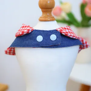 Detailed view of checkered pet bandana with denim fabric and blue buttons on a white mannequin