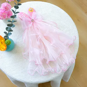 Pink pet dress detail with silk bow, heart jewel, and multi-layer sequin mesh tulle