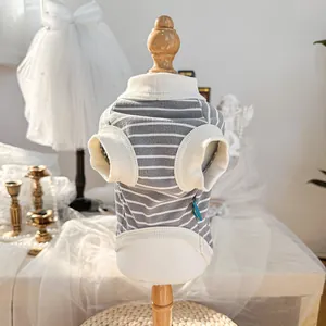 Detail of striped pet t-shirt with white ribbed edges on a wooden dog mannequin