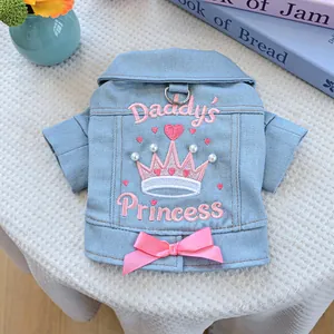 Detail of dog denim jacket with Daddy's Princess embroidery, pearls, and pink bow