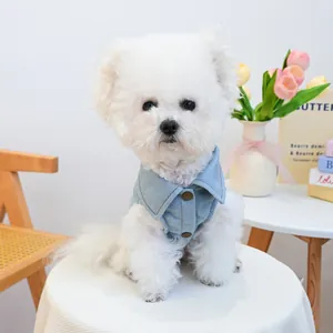 Close-up of light blue denim pet vest featuring metal buttons and stylish collar detail