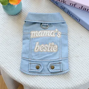 Detail of light blue denim dog vest featuring mama's bestie embroidery and metal D-ring