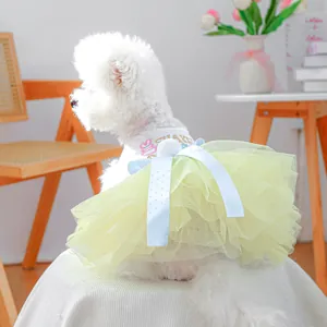 Detail of dog dress with embroidered cake graphic and yellow layered mesh tutu skirt