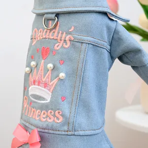 Close-up of pink Daddy's Princess embroidery and pearls on blue denim dog jacket