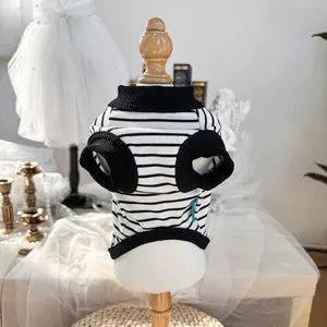 Macro shot of striped pet vest with black ribbed edges on a vintage mannequin display