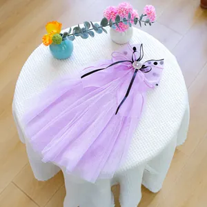 Detail of light purple pet wedding dress with mesh layers and pearl bow decoration