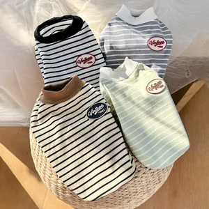 Detail showing vintage striped knit dog vests in four colors with EST 1993 woven patches