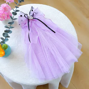 Detail of lavender tulle pet wedding veil with black polka dots and rhinestones