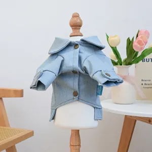 Detail of light blue pet denim jacket showing vintage buttons and brand logo tag