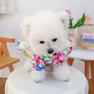 Detailed close-up of a floral dog bandana with ruffles and vibrant summer flower prints