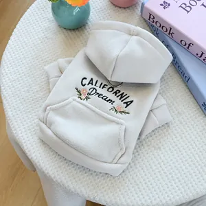 Detail of cream fleece dog hoodie featuring California Dream embroidery and metal D-ring