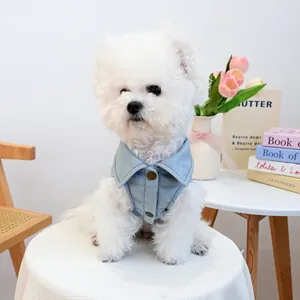 Cute light blue denim pet vest with metal buttons for small dogs shown on a white table