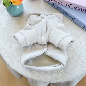 Close-up of cozy beige fleece pet vest with snap buttons and soft ribbed edges