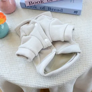 Detail of warm off-white fleece dog hoodie with soft texture and white resin snap buttons