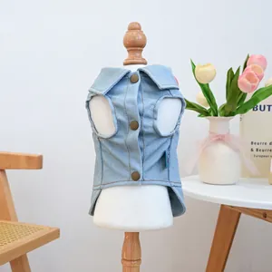 Detail of light blue denim pet vest featuring vintage metal buttons and collar design
