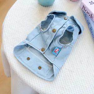 Detail of light blue pet denim vest with retro metal buttons and cartoon fabric label