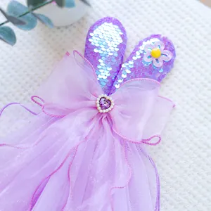 Detail of purple sequin rabbit ear headpiece with organza bow and heart gemstone