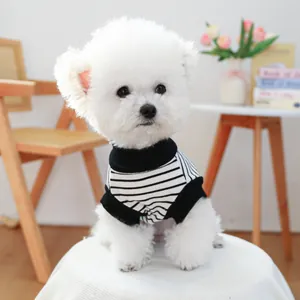 Detail of a high-neck black and white striped knitted pet vest on a white dog