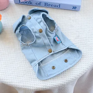 Detail of light blue denim pet vest showing vintage metal snaps and side fabric label