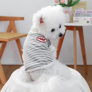 Detail of vintage grey striped dog vest with red embroidery on soft cotton fabric
