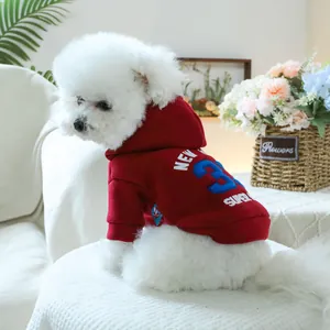 Detail of red pet hoodie featuring blue number 3 and athletic New York lettering for dogs