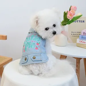 Detail of light blue denim pet vest with Cutie Pie embroidery and cherry motifs