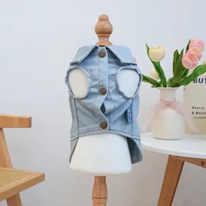 Detail view of light blue washed denim pet vest with copper buttons on a white mannequin