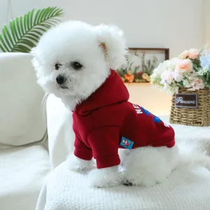 Detail of red pet hoodie on small dog featuring fleece lining and high-quality printed logo