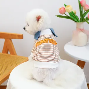 Close-up of striped dog shirt featuring letter embroidery and functional metal D-ring