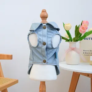 Detail of light blue denim pet vest with vintage buttons and classic turn-down collar