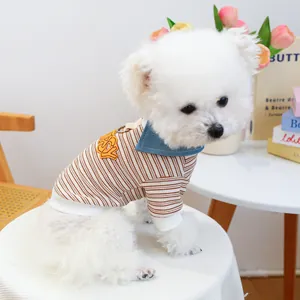 Detail of dog striped knit sweater featuring blue denim collar and Happy embroidery