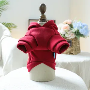 Detail of warm red pet hoodie showing soft fabric texture and ribbed cuff design