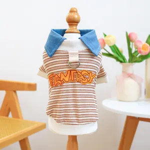 Detail of pet striped t-shirt with denim collar, fantasy patch, and metal D-ring attachment