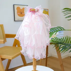 Macro detail of pink layered tulle pet wedding veil with a sequined fish bow on a stand