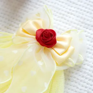 Detailed close-up of a red satin rose and heart-printed mesh bow for pet accessories