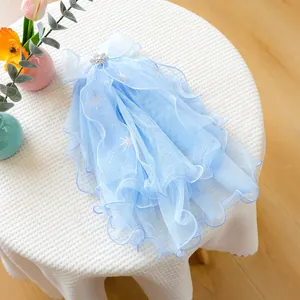 Close-up of light blue pet wedding veil with snowflake charm and silver star prints