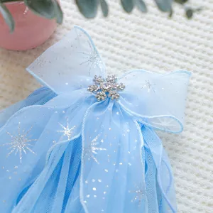 Detail of light blue mesh bow hairclip with silver snowflakes and rhinestone heart