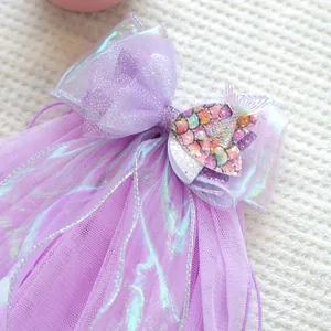 Detailed view of purple mermaid tail bow with shimmering mesh and pearl accents