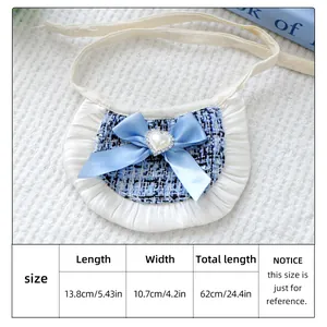 Detailed view of tweed pet bandana with blue silk bow and heart-shaped pearl buckle