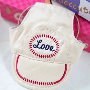 Detailed macro shot of beige pet baseball cap with Love embroidery and red stitching
