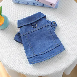 Classic blue denim dog jacket with D-ring harness and orange stitching on white background